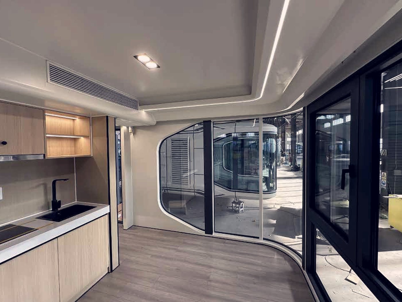 Kitchenette and full-height glazing in a garden studio