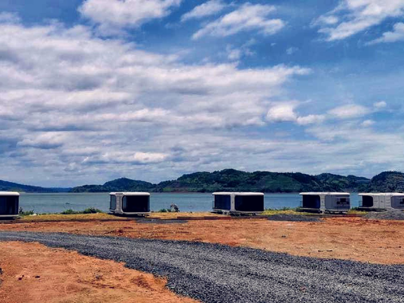 Units along a lakeshore, set on gravel pads