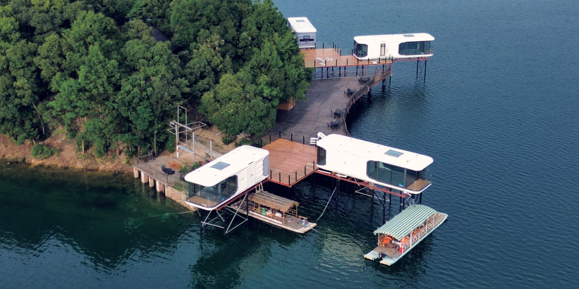 Capsule cabins on stilts over a lake at a tourism destination